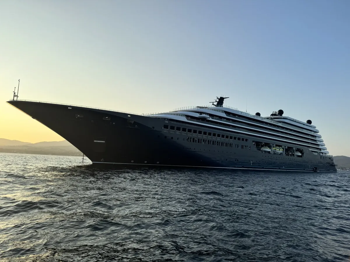 Luxury ocean cruise ship sailing at sunset