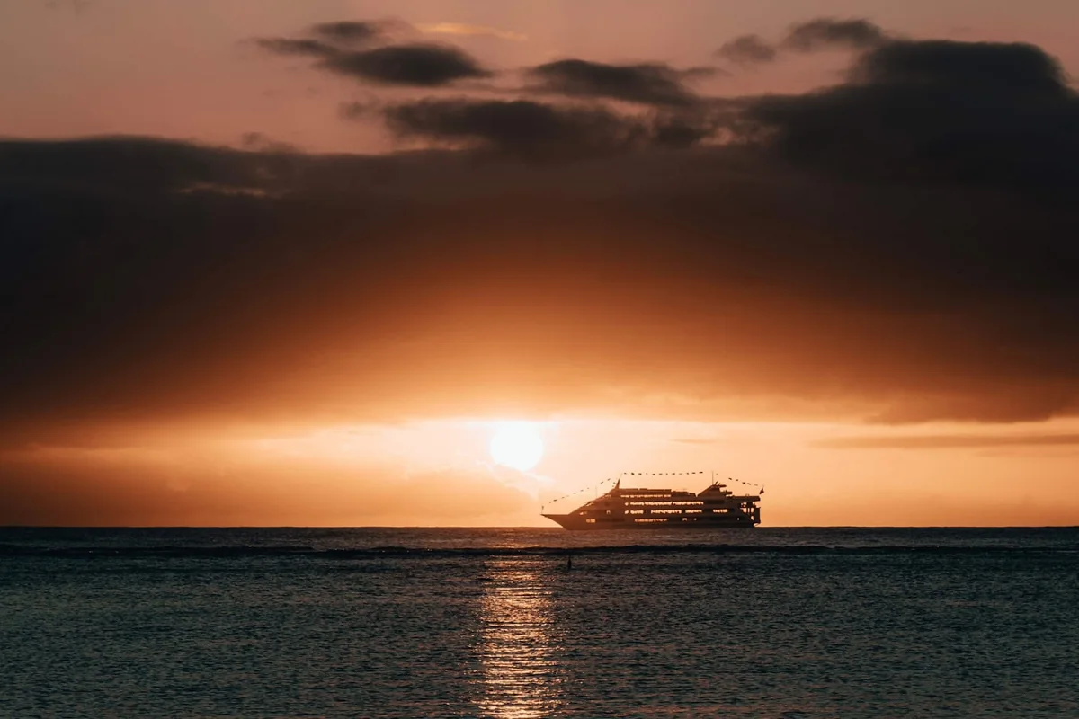 Cruise ship crossing the ocean at sunset